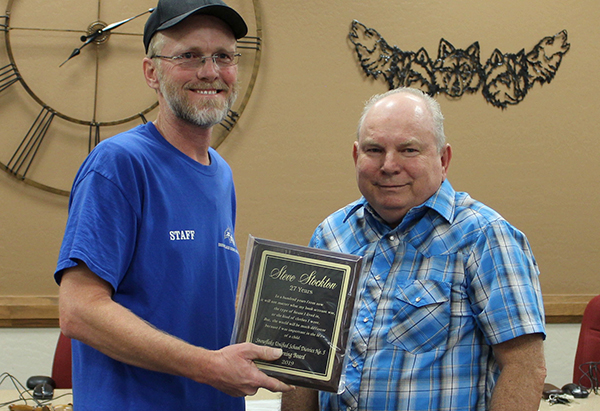 Photo by Toni GibbonsNathan Cornell (left), lead custodian with the Snowflake Unified School District, presented retiring Snowflake High School custodian Steve Stockton (right) with a plaque of appreciation for 27 years of service to the district. Cornell noted of Stockton, “It’s been a pleasure to work with you. You have always gone above and beyond everything I ever asked of you and I wish you nothing but health and happiness in your retirement.”