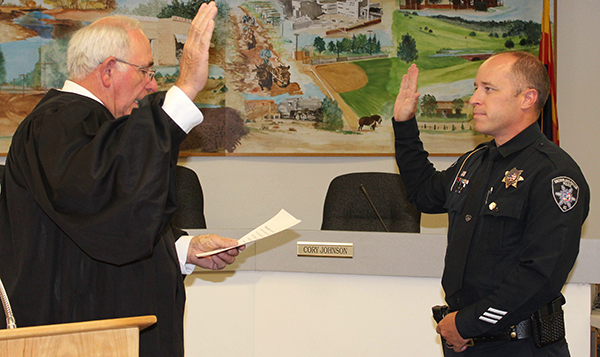 Photo by Toni GibbonsThe Honorable Judge Fred Peterson (left) swears in Lieutenant Bobby Martin (right) as the new Snowflake-Taylor Police Chief on June 28 at the Snowflake Town Hall.