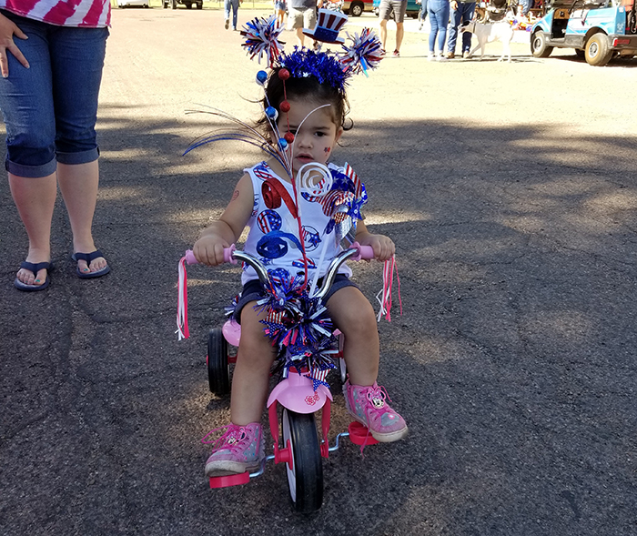 Photos by China CassidyArizia Garcia, the granddaughter of Tara Young of Holbrook, took to the parade in a tricycle outfitted for the holiday.