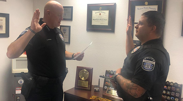 Photo courtesy of Winslow Police DepartmentThe Winslow Police Department welcomed Officer Aaron Canyon (right) to their ranks last week as a lateral police officer transfer. Here Police Chief Dan Brown (left) swears in Canyon as he begins his job serving the people of Winslow.