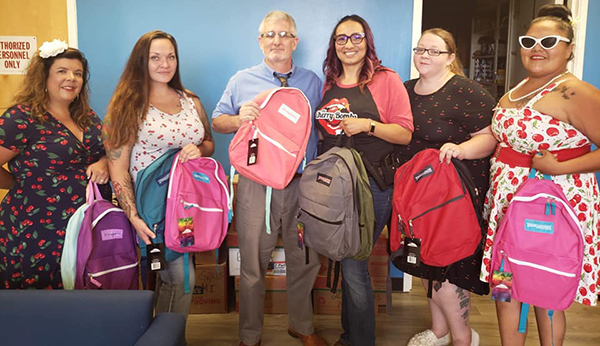 Photos courtesy of The Cherry BombsEvery school in Winslow, Holbrook and Joseph City received supplies from The Cherry Bombs who raised funds for the project from raffles and an online call to the public. Holbrook High School Principal Lance Phaturos (pictured center) thanked Cherry Bombs (left to right) Jillian Stotts, Jami McPherson, Tanisha Gamez, Charleigh Betts and Karen Johnson.