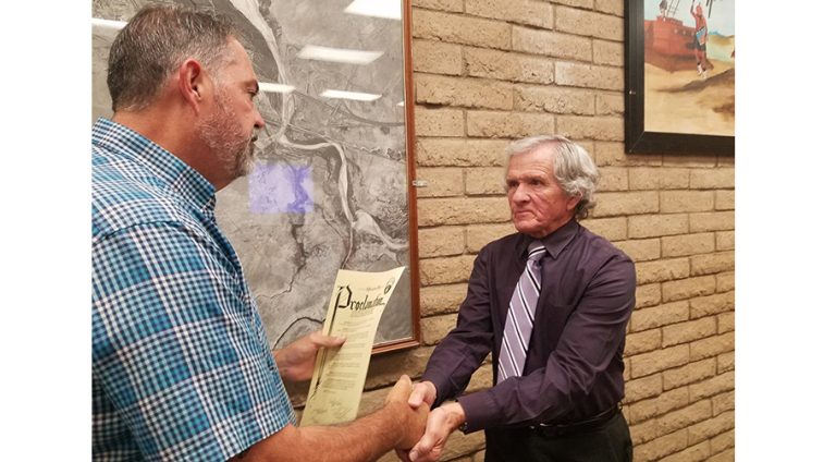Photo by L. ParsonsLocal radio personality, Loy Englehardt (right) accepts a proclamation from Mayor Tom McCauley (left) at last week’s city council meeting.