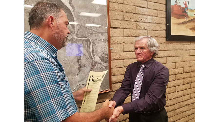 Photo by L. ParsonsLocal radio personality, Loy Englehardt (right) accepts a proclamation from Mayor Tom McCauley (left) at last week’s city council meeting.