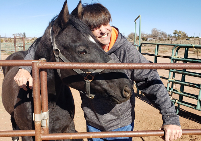 Photo courtesy of Tom ZiebellTom Ziebell (pictured), owner of Great Spirit Animal Sanctuary, shares some love with one of the sanctuary’s rescue horses, Romeo. The sanctuary offers a permanent home for injured and unwanted animals.