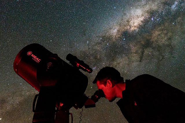 Photo courtesy of Frank KraljicFrank Kraljic views the Milky Way through his telescope in Namibia, South Africa.