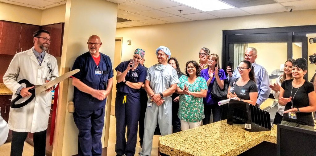 Photo by Tess KennaLast July, the Little Colorado River held a ribbon cutting for their new wound care center. Here, Dr. Brian Bucina holds the ceremonial scissors as hospital staff and visitors look on.