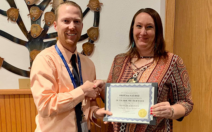 Photo courtesy of Navajo CountySheena Valdez (right) was recognized by Human Resources director Eric Scott (left) for her 20 years of service in the Adult Probation Department of Navajo County.