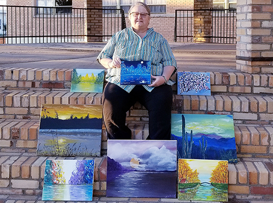 Photo by China CassidySue Dixson shares some of her many acrylic paintings and a new one she recently completed with water color, (bottom right) a different method than her usual acrylic.