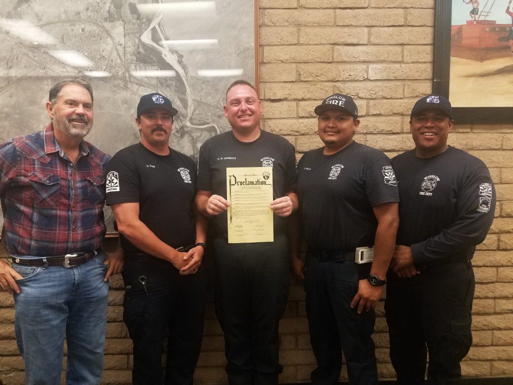 Photo by L. ParsonsMayor Tom McCauley (left) presented members of the Winslow Fire Department (left to right), Dustin Cole, Michael Lawrence, Derek Begay and Nolan Horn with a proclamation declaring the week of Oct. 6-12 as Fire Prevention Week in Winslow.