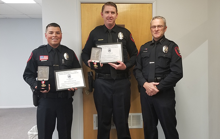 Photo by China CassidyHolbrook Police Officers Michael Kennedy (left), Michael Theobald (center) were awarded the Life-Saving Award by Chief Nathan Christensen (right) at the Oct. 24 city council meeting.