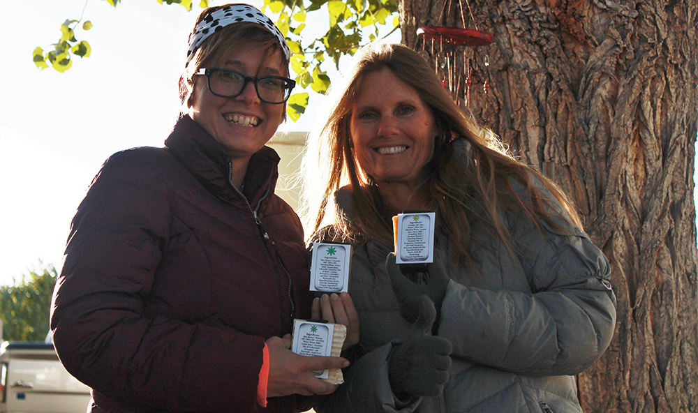 Photo by Amanda NicholsTiponi (left) and her mother Bonita (right) proudly show off some of their new medicinal soaps in front of their workshop at home in Snowflake.