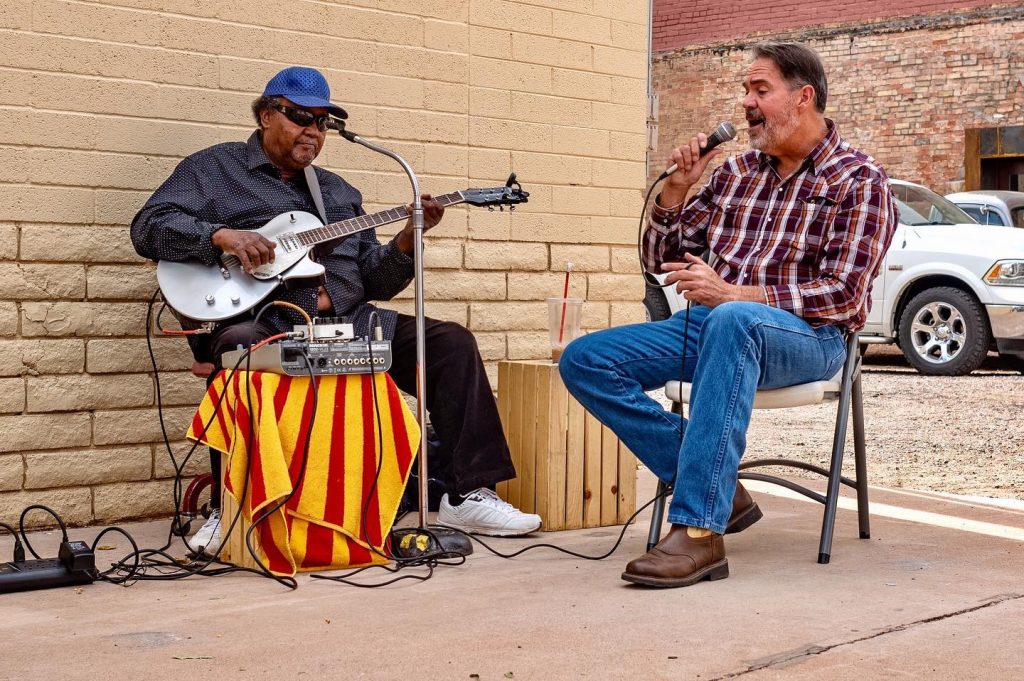 Photo by Brian LawWinslow Mayor Tom McCauley (left) can often be spotted singing alongside Arizona Blues Hall of Fame member Tommy Dukes (right) outside of Route 66 Trading Company, located at 101 E. Second St. The location has not only become a hot spot for visitors but also for locals to socialize.