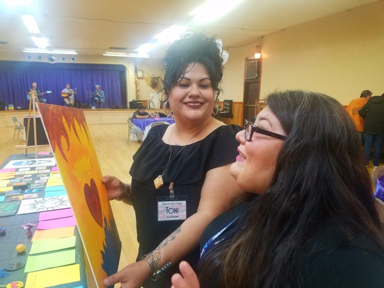 Photo by L. ParsonsWinslow Arts Council members Monique Chavez (right) and Toni Spex (left) admired one of hundreds of pieces of art at the Great Big Tiny Art Show held last week at the Winslow Elks Lodge. The event was a fundraiser for the Elk’s Lodge Clothe a Child program.