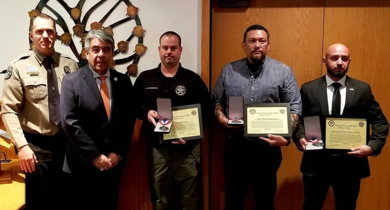 Photo by L. ParsonsNavajo County Sheriff David Clouse (left) and U.S. Marshal David Gonzalez (second from left) presented a Medal of Valor to three officers for their bravery in a dangerous incident that occurred Oct. 10. Those honored were NCSO Lt. Scott Peterson (center), Sgt. Wayne Lesperance (second from right) and U.S. Marshall T. Traistaru (far right).