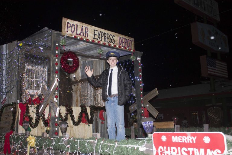 Photo by Linda KorHundreds gathered to watch and take part in the annual Holbrook Parade of Lights last Saturday. Arizona Public Service once again impressed, with their float themed Polar Express with a young conductor welcoming passengers to come aboard.