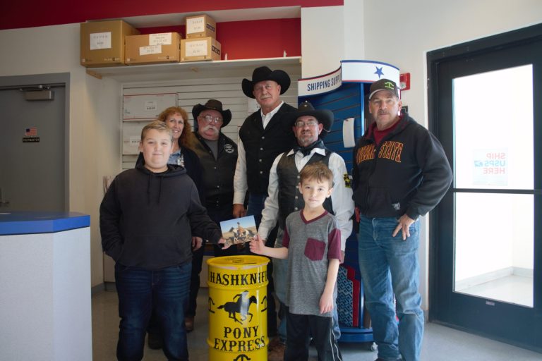 Photo by China CassidyOn Dec. 16, members of the Hashknife Sheriff’s Posse rolled out the barrel for next year’s 2020 Pony Express ride from Holbrook, through Payson to Scottsdale to begin on Wednesday, Feb. 5. Mail can be dropped off inside the Holbrook Post Office. This year William (left) and Patrick (second from right) Cassidy continue the Kelley family tradition of placing the first piece of mail in the barrel. The barrel will remain at the post office until Tuesday, Feb 4. Pictured are (left to right) postal employee Sharon Peterson, Bill Perkins, Scott Self, John Veendendaal and Tim Kelley. Barrels are also available at the Winslow, Snowflake and Joseph City post offices.