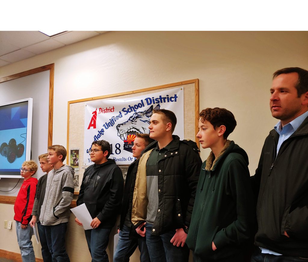 Photo by Tohna RogersSnowflake Junior High School students present the project that earned them the title of state winners for a second year to the Snowflake Unified School District Governing Board. Pictured are (left to right) Sam Whittle, Ben Sundby, Shaun Davies, Talan Story, Kai Rammage, Mason Reidhead, Britt Brimhall and teacher Michael Eilertsen.