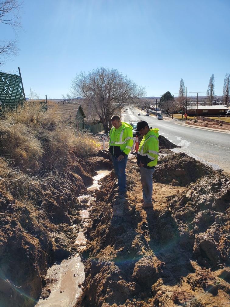 Photo courtesy of Randy Sullivan Water/Wastewater Supervisor Randy Sullivan (left) and crew member Byron Shelendewa (right) have been working with the rest of the water department to isolate the leak that continues to run down Eighth Avenue to prevent further damage to the road. According to City Manager Ted Soltis, the city is having some difficulty locating equipment needed to locate the leak, which they believe is coming from a natural spring.