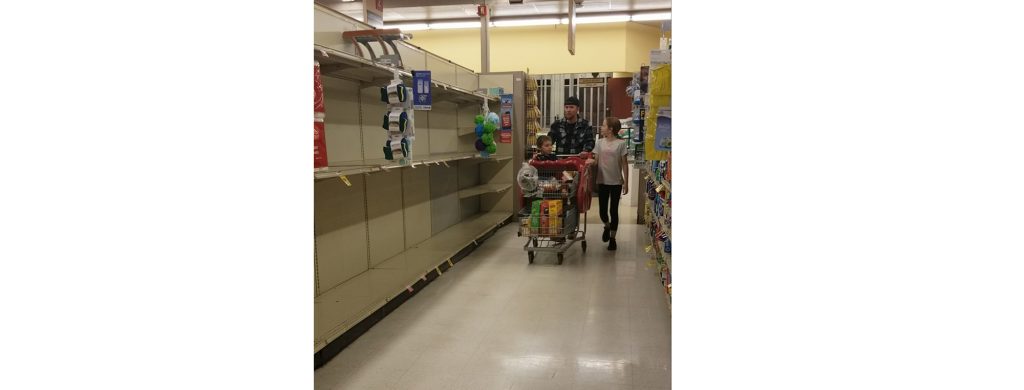Photo by China CassidyKris Kennedy and two of his children, Krystopher (left) and Kiana Kennedy (front) experienced firsthand the effects of panic buying on Sunday, March 15, when they were met by empty shelves. Grocery stores everywhere are struggling to maintain supplies with the demand of shoppers looking to stock up due to concerns of quarantine.