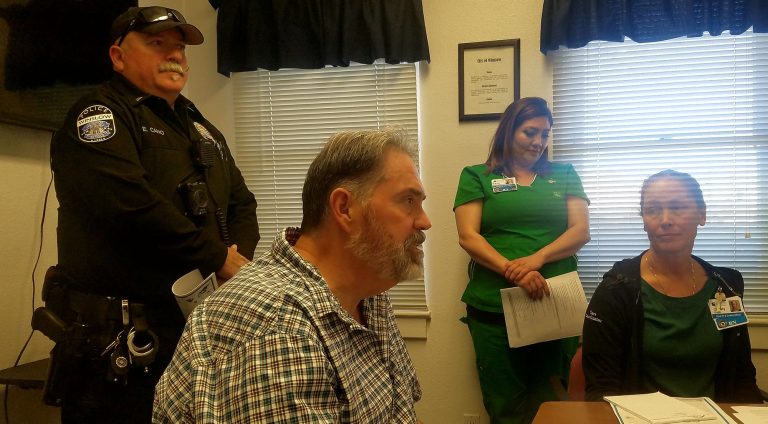 Photo by L. ParsonsWinslow Mayor Tom McCauley (seated) addressed the Winslow City Council while members of the Winslow Police Department and Little Colorado Medical Center staff looked on.