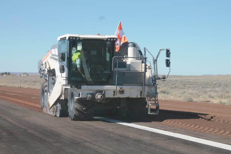 Photo by China CassidyOn Tuesday, March 24, Phoenix based company, Sunland Asphalt, began work on the Holbrook Municipal Airport, which is expected to be completed by May 30. According to Kendra D. Riley, a representative for Sunland, there will be a full runway closure and the taxiway/apron will remain open to pilots, the local aviation association and the Holbrook City Staff. Part of the process requires a pulverizer that pulls up the existing asphalt and breaks it down into finer material, which is picked up by a skip loader, stockpiled and reused as part of the subgrade. Subgrade is the layer of material laid down before placing the new asphalt.
