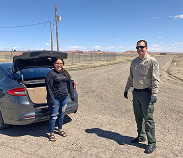 Photo courtesy of Northland Pioneer CollegeSheriff Clouse of the NCSO loads a box full of Chromebooks into Kayenta Center Advisor Chantal Kescoli’s car for use by needy NPC students in the area.