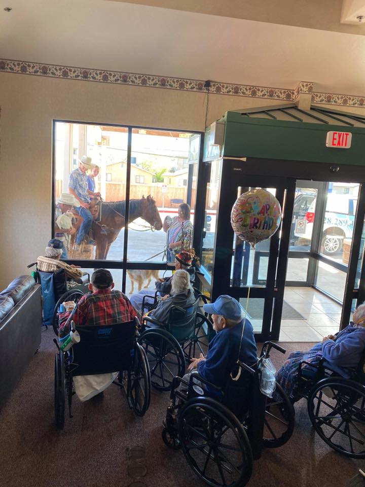 Photo courtesy of Winslow Campus of CareAlan and Vicky Palmer of Joseph City, along with their kids Kaci and Blake, visited the senior citizens staying at the Winslow Campus of Care with their farm animals in an effort to bring some joy to the residents and staff, and they did just that. Since the residents couldn’t come outside due to the quarantine, the Palmers made their way along the exterior of the building, showing their goat, horses and dog to those inside. To see the video of the visit and other videos of life on a farm, visit The Farm on Route 66 Family Homestead on YouTube.