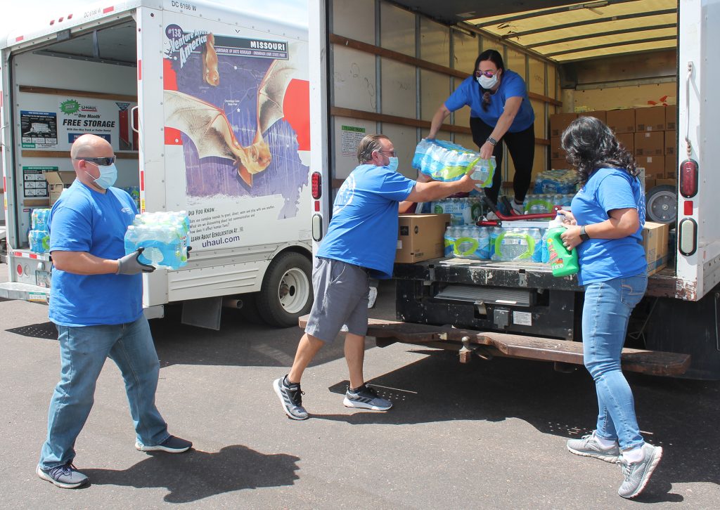 Photos by Linda KorEncompass Health East Valley and Scottsdale Rehabilitation hospitals joined together to organize a water and supply drive to directly benefit the Navajo Nation. Reanna Baldonado (right) organized the drop off in addition to securing members from the Holbrook and Navajo community to help unload the supplies. Those taking part in the endeavor included Navajo County District 1 Supervisor Lee Jack (cowboy hat) and District II Supervisor Jesse Thompson (front row, black baseball cap), as well as hospital staff Diana Fischer ABDD, Kenneth Bell CEO, Kevin Ekstrom Rehab Liaison, Ramie Quiroz Rehab Liaison, Reanna Baldonado Rehab Liaison, Steven Lacombe Outpatient Scheduler and Chris Bourn Community Volunteer.
