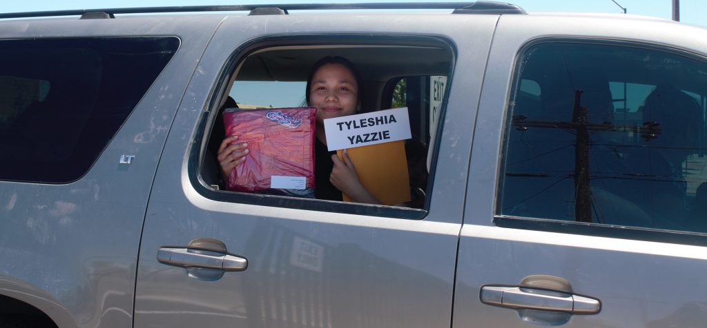 Photo by China CassidyTyleshia Yazzie (pictured) and her fellow seniors of 2020 picked up their cap and gowns drive-in style on Tuesday, May 12, in preparation for this week’s graduation.