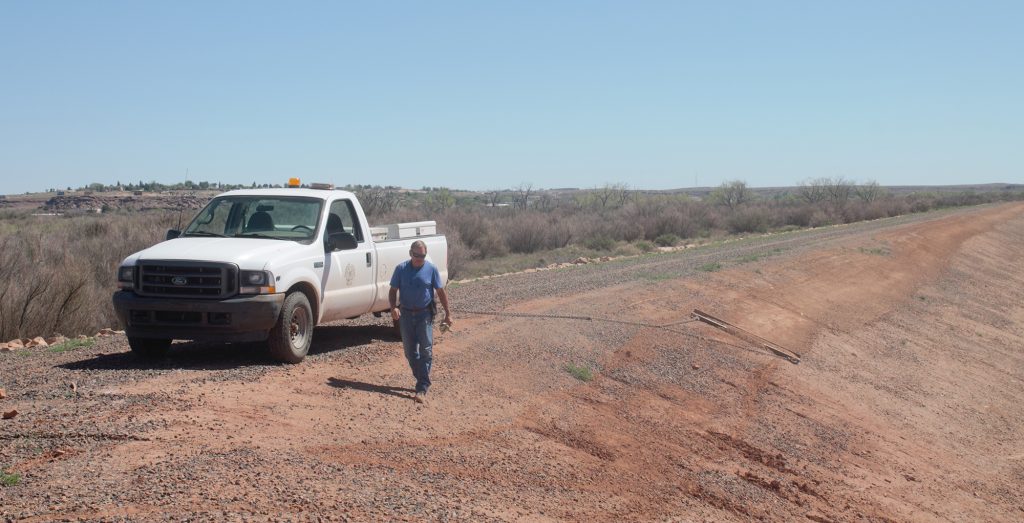 Photo by China CassidyLevee Superintendent Tim Kelley uses an eight-foot wide piece of railroad tie connected to a chain hooked onto the back of the truck which he drags across the levee, filling in the deep reels caused by rain and recreational vehicle traffic.