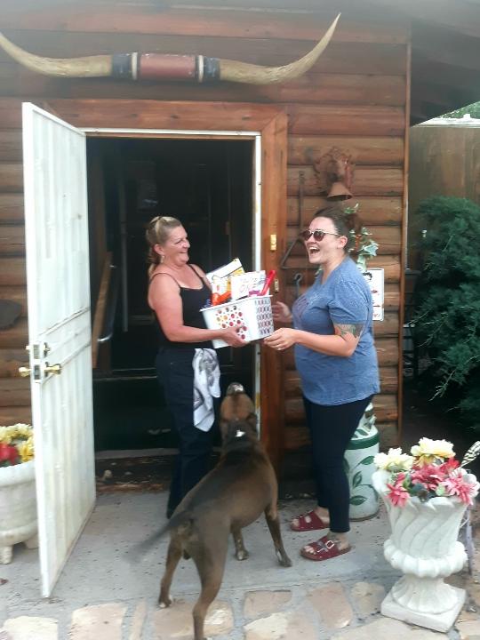 Photo by China CassidyCreator of the Facebook group Wine a Friend in Navajo County, Jaime McPherson (right), delivered a non-alcoholic basket to Lorna Barger (left) of Holbrook, on Thursday, May 28.