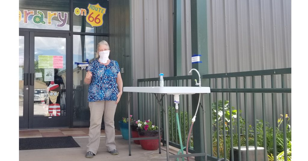 Photo by China CassidyHolbrook Public Librarian Wendy Skevington (pictured) and the crew at the library have set out a hand washing station for patrons to use before they enter the library. Skevington said that while it is not required, they are asking that people wear masks if possible when entering the facility, which is now open.