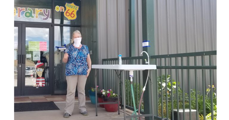 Photo by China CassidyHolbrook Public Librarian Wendy Skevington (pictured) and the crew at the library have set out a hand washing station for patrons to use before they enter the library. Skevington said that while it is not required, they are asking that people wear masks if possible when entering the facility, which is now open.