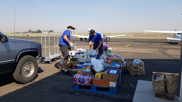 Photo by China CassidyPilot Jim Yost (left) and Mitch Pruitt (right) are both part of The Wings of Faith non-profit organization that came to Holbrook to help load several pallets of food to be delivered to the Navajo, Apache and Hopi reservations.
