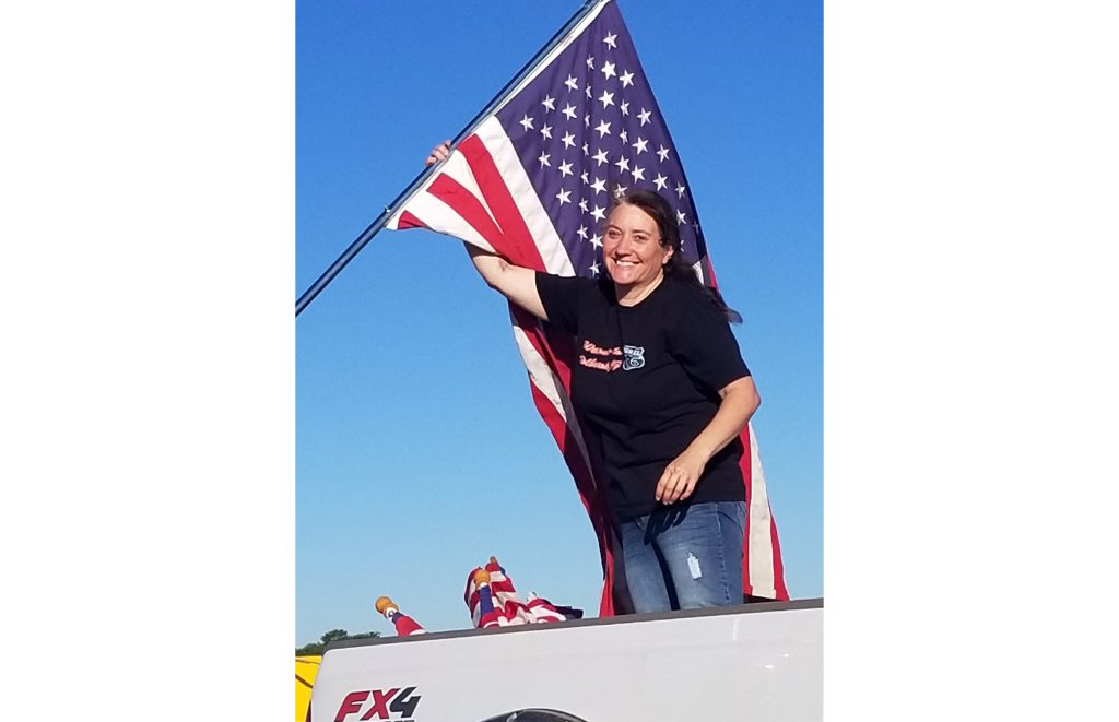 Photo by China CassidyKathleen Gardner Smith (pictured) was one of several volunteers who helped put the flags up along Hopi Drive and Navajo Blvd. in Holbrook for the Fourth of July holiday.