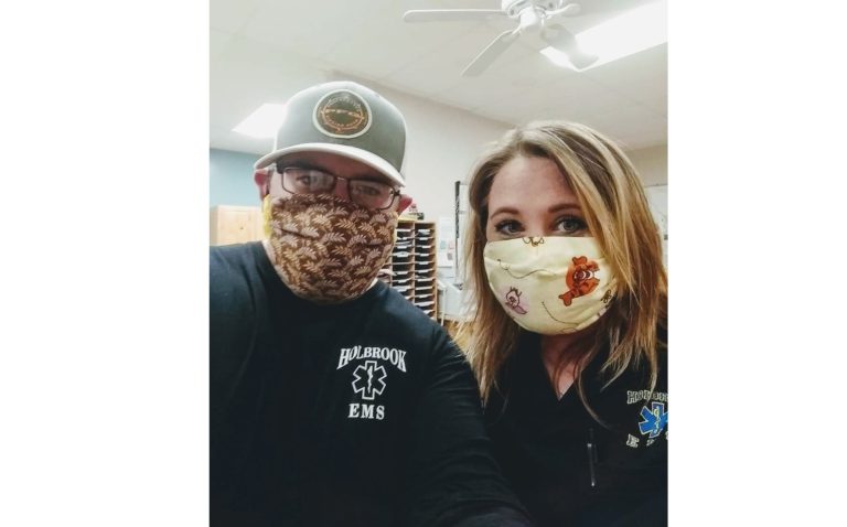 Photos by Becky SladeIn the photo on the left Becky Slade (right), co-worker Josh Stump (left) and the rest of the crew at Holbrook Emergency Medical Services wear a mask as part of many precautions taken to help prevent the spread of COVID-19. On the right, Slade and her son James Mitchell (right) demonstrate safe practices as a family in their colorful facemasks.