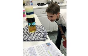Photo courtesy of Sandy FoutzAs many area families decide to continue schooling from home even after schools open, what that education will entail is a new task to consider. Here 13-year-old Geoff Foutz (pictured) of Holbrook can be seen enjoying a density experiment did as part of his curriculum from home.