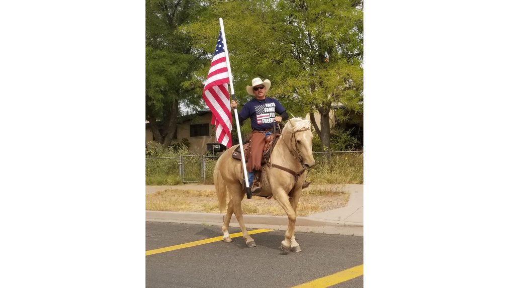 Photo by China CassidyIn honor and memory of the Americans who lost their lives and the lives of family as a result of the terrorist acts of 9/11, Holbrook resident Tim Kelley rides on horseback with the American flag traveling nine blocks south down Navajo Blvd. and 11 blocks west on Hopi Drive.