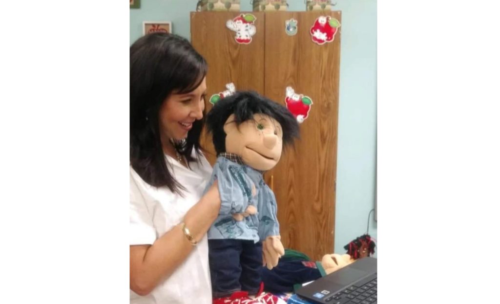 Photo Courtesy of Holbrook Unified School DistrictWith distance learning being the only option for students of Holbrook Unified School District during Phase 1 of the 12 point back to school plan, pre-kindergarten to second grade speech therapist Amanda McNabb Remos and her speech puppet George continued their instruction virtually with the students.