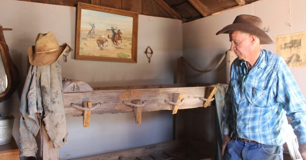 Photo by China CassidyInside the charming little hashknife bunkhouse, Baird (pictured) has an old rope bed that was used by cowboys passing through to ship cattle. The pioneer display is only a small portion of his collection. The rest of his collection such as old tractors, well drills and corn wagons can be found at his Pioneer Museum on Main Street in Joseph City. In a private room inside the museum, Baird has a collection of delicate pottery, water ollas, jewelry, baskets and other items believed to be anywhere from 1,000 to 1,200 years old. The baskets, according to Baird, were used by the Navajo for transferring water, contrary to the common belief that they used pottery. Many of the pots and baskets are intact but secured inside glass cases for extra protection. Baird told of how the larger pots were used to fend off dehydration during long travels. Baird explained, “On the trail, the Hopi’s told me every five miles they would bury these about halfway in the sand and it was somebody’s job to keep them full of water. They couldn’t just head out because they would be choking. So, they had to know that every five miles they had one of those.” Just another short drive through a bumpy dirt road are Anasazi pueblos, which were excavated over the course of five years by archeologists and field students who would stay at the ranch for five weeks at a time while working to reveal the structures. The trail leading up to the pueblos has pottery and arrowheads scattered on both sides. Inside the building that protects the old structures are living quarters where three families stayed. Baird offered, “This is the actual footing of their houses. They figured these were two story buildings.” It is obvious that each room had its own function and what that function was. A charcoal pile sits in the corner where they were believed to do their cooking. Holes in the ground show where pots were put to store water or food such as grain of rice. After visiting the pueblos, there are also two hogans, a sacred home of the Navajo people, on the property for viewing. What the locals call the “swimming hole” can be found further down the canyon where the walls that line the water are covered in old petroglyphs. Baird said he would love to see more people visit the ranch saying, “This is not my museum, this is our museum, and if there’s any time that anybody feels that we can upgrade it by doing something that they have, they’re welcome.” Rock Art Ranch is open at 10 a.m. Monday through Saturday and is located off Territorial Road between Joseph City and Winslow. For tours and to schedule reservations, visit rockartranch.com or call (928) 386-5047. Admission is $35 per person.