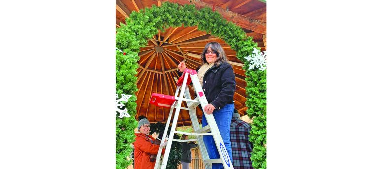 Photo courtesy of Holbrook Chamber of CommerceEvery year, residents and members of the Holbrook Chamber of Commerce get together at the Navajo County Historic Courthouse to decorate the grounds for the Christmas Holiday. Chamber Director Cindy Tafoya (on ladder), and Katrina Jaime (left) as well as other members of the community teamed up to decorate the gazebo, the trees and the top of the Historic Navajo County Courthouse in downtown Holbrook.