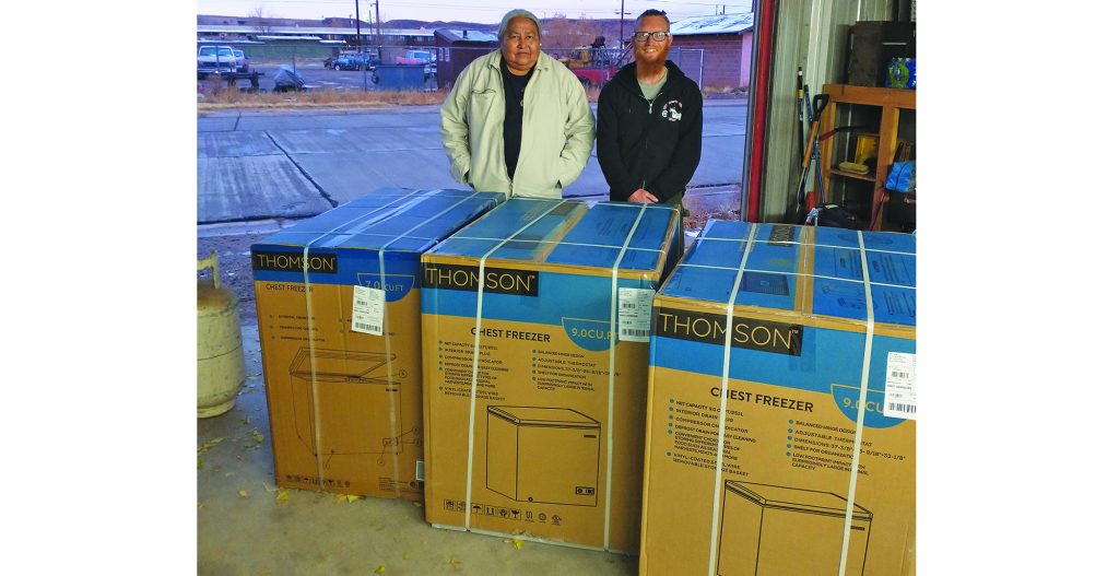 Photo courtesy of Jason DanchJason Danch (right), owner of the Winners Circle Bar in Holbrook surprised Lou Yazzie (left) and the rest of Operation Love with three freezers to help store the frozen goods that are brought by the United Food Bank in Mesa, between Saturday distributions.