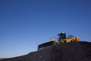Photo courtesy Peabody EnergyA bulldozer crawls over a pile of coal at the Kayenta Mine on the Navajo Nation in this photo from 2012. The mine closed in 2019, but a program that distributes free coal to tribal members, one ton at a time, continues this year with coal from another mine on the reservation.