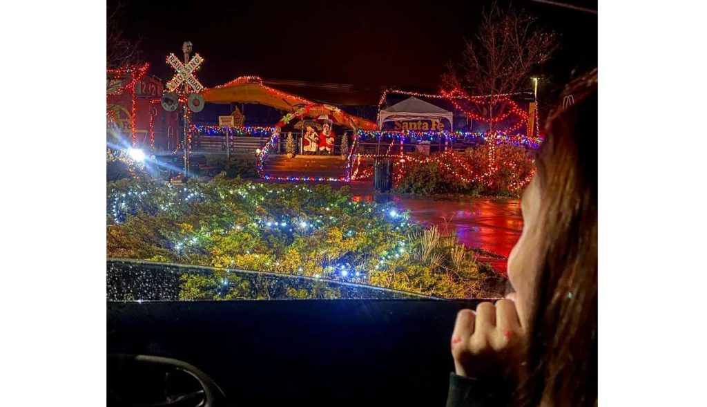 Photo by Talisha GalvanNine-year-old Brooklyn Padilla looks out the window of her grandmother Cathy Galvan’s car at Santa and Mrs. Clause as they arrive on the Santa Train in Winslow. The annual Santa Train event was modified this year due to the COVID-19 pandemic, but the Winslow Recreation Department and volunteers were still able to bring the magic to children in the area.