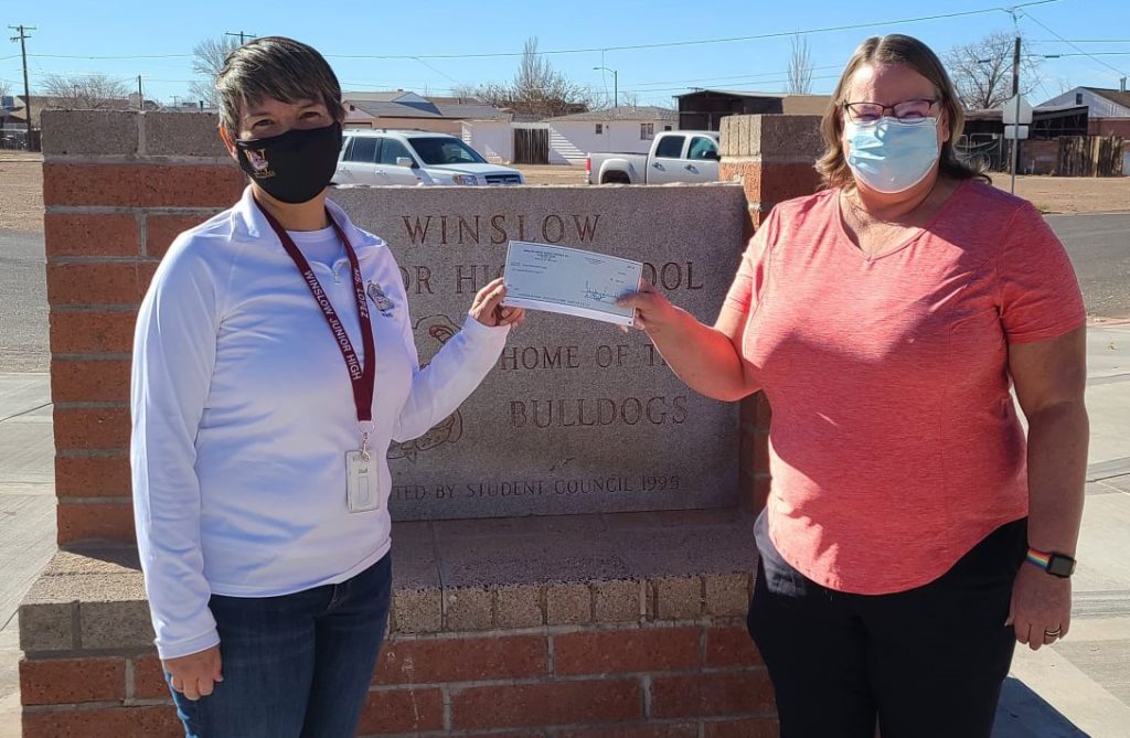Photo courtesy of Winslow Junior High SchoolWinslow Junior High School Principal Deb Lopez (left) presented Winslow BPOE Elk’s Lodge member Michelle Pennington (right) with a check for $247 last week. Students and staff at the school raised money through their “Put a Cap on Hunger” program. The money will be used to help fund the annual Elk’s Christmas Baskets program in which the Lodge supplies holiday meals and toys to underprivileged families in Winslow.