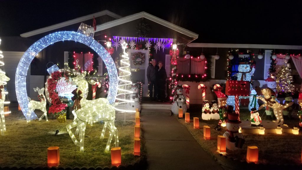 Photo by China CassidyAlfred and Kathy Sample (center) have brought holiday joy to people from locals, to global travels for the past 40 years with their holiday décor.