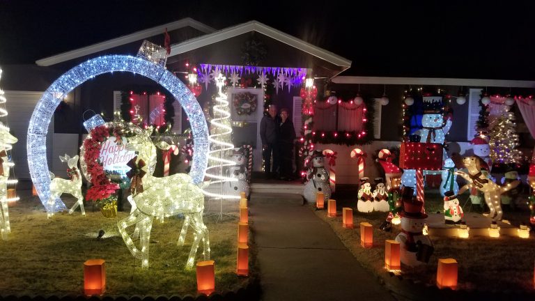 Photo by China CassidyAlfred and Kathy Sample (center) have brought holiday joy to people from locals, to global travels for the past 40 years with their holiday décor.