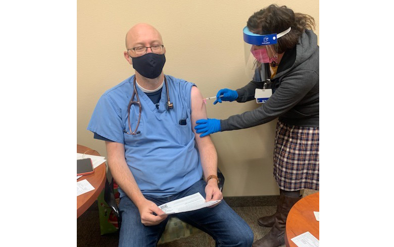 Photo courtesy of Little Colorado Medical CenterLittle Colorado Medical Center Chief of Staff Dr. Thomas Greenwood (left) was among the first recipients of the Moderna COVID-19 vaccine. Here, it is being administered to Greenwood by a medical assistant.