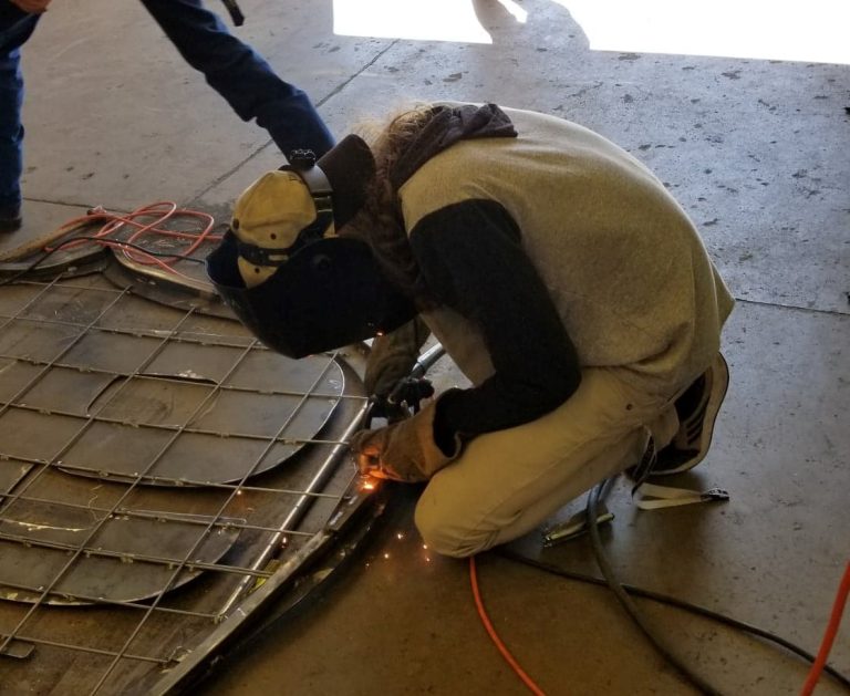 Photo by Daniel TafoyaWinslow High School Class of 2020 graduate Dylan Sellens (pictured) welds together parts of the new Route 66 sign.