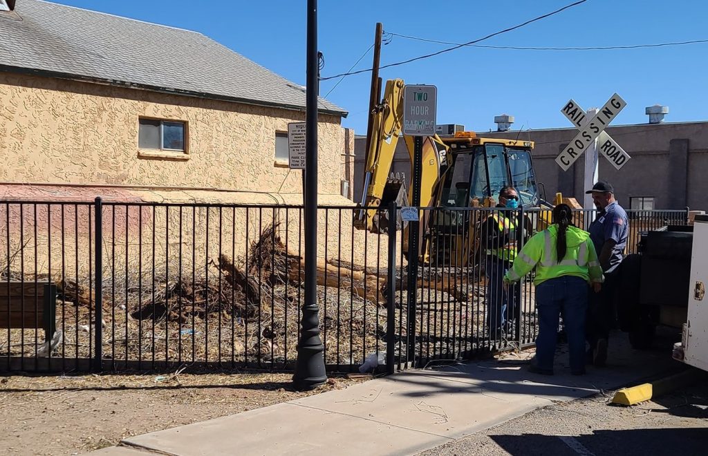 Photo by Tess KennaCity of Winslow employees discuss plans to move the “birthplace cabin” to a park between First and Second Streets on Williamson Avenue in Winslow.